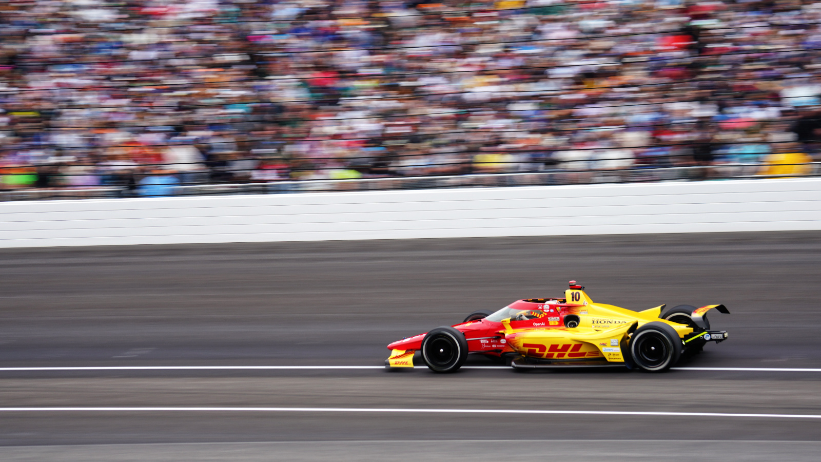 Palou flies past grandstands filled with cheering fans. Photo: Kevin Dejewski