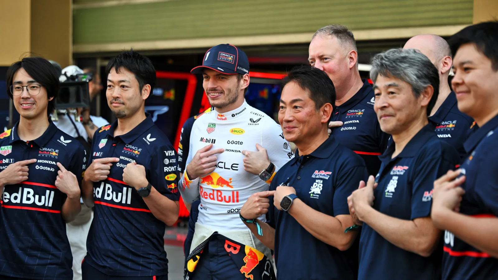 Max Verstappen has been praised by Honda president Koji Watanabe [front, third from right]