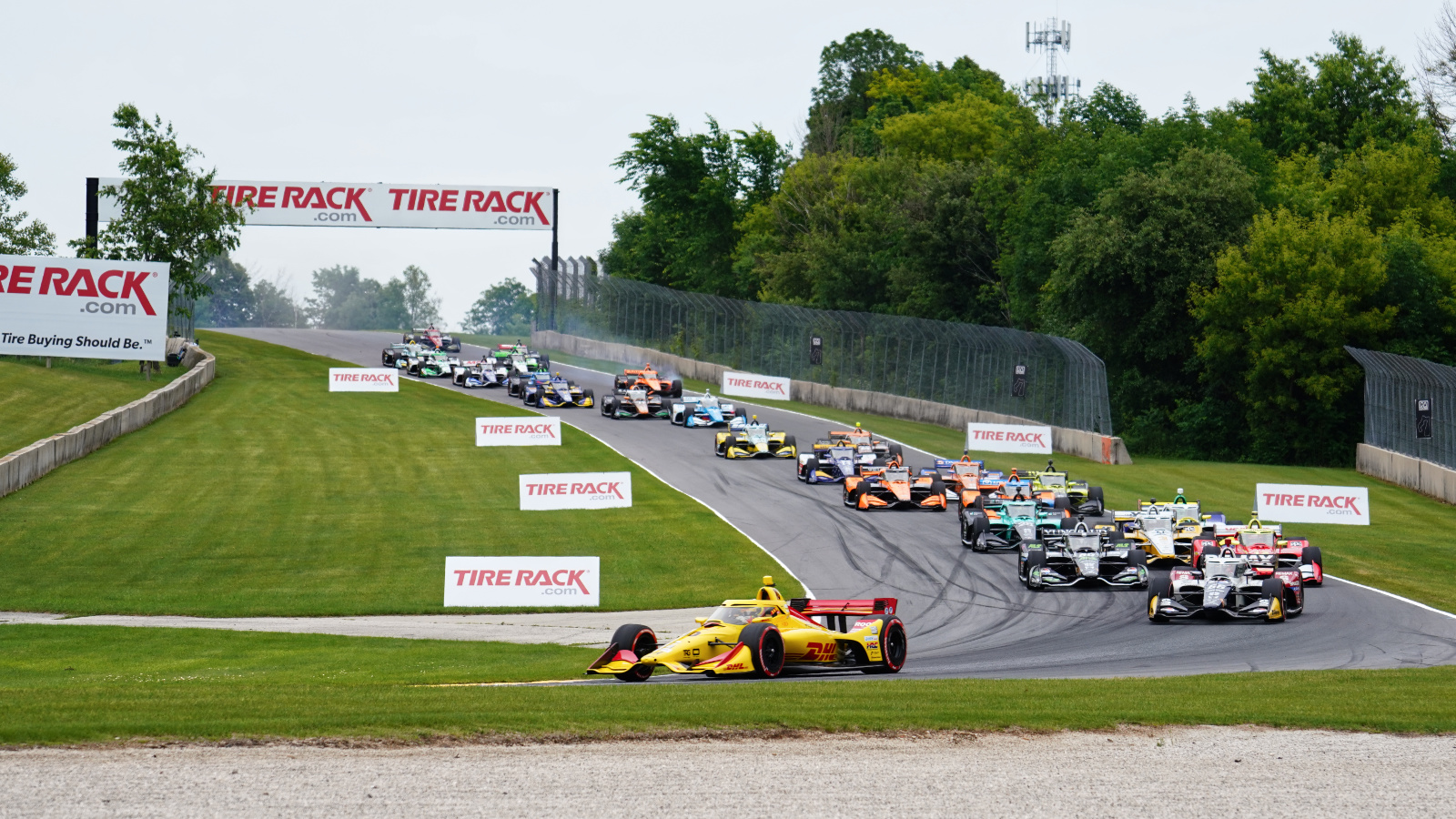 The field piles through Turn 3 on the first lap. Photo: Kevin Dejewski